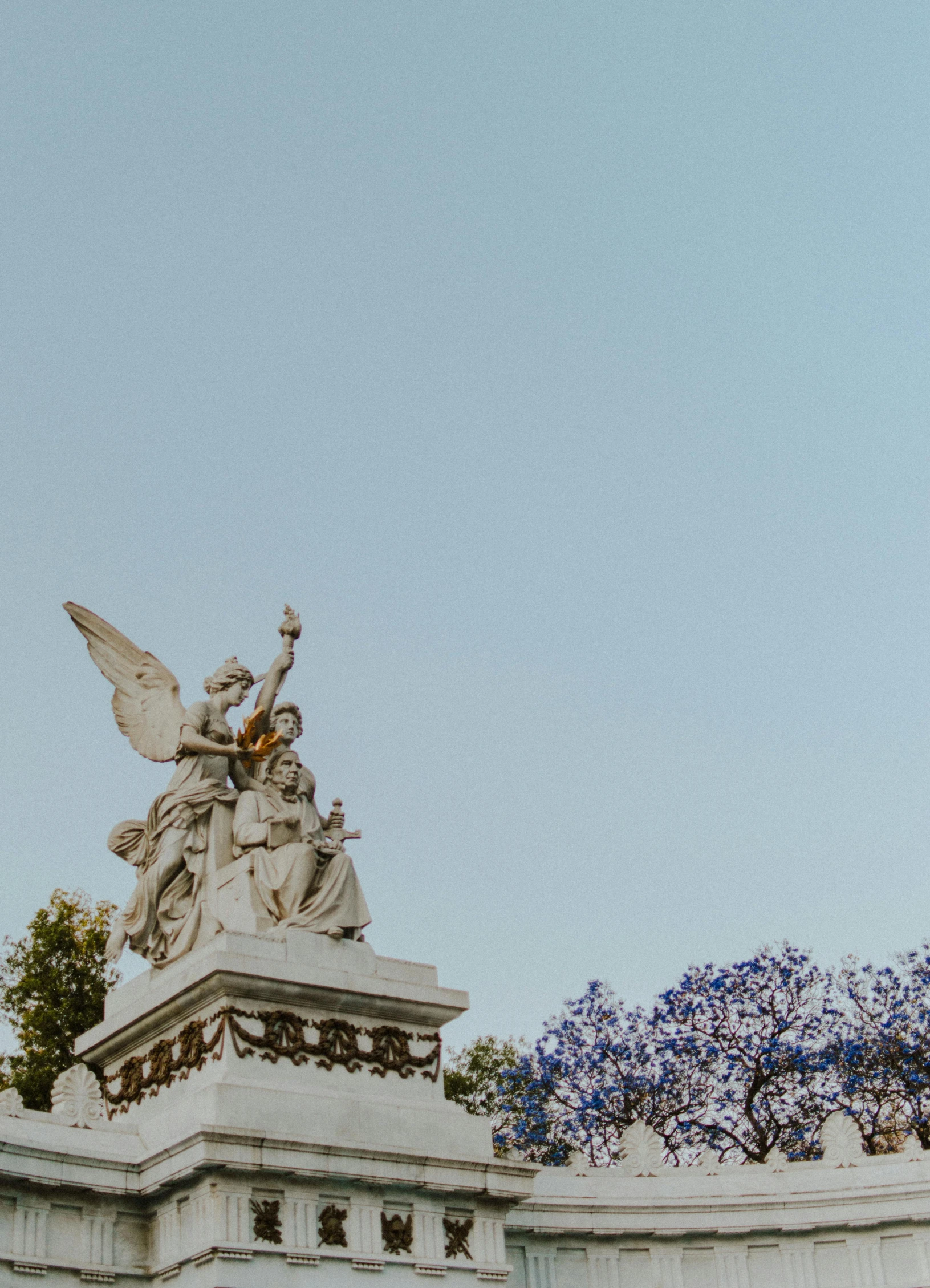 a statue in the center of some trees