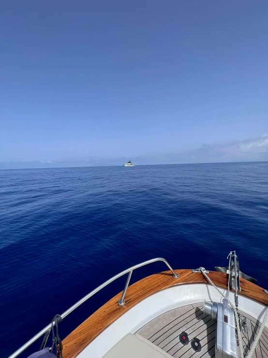 boat on open water traveling in clear blue ocean