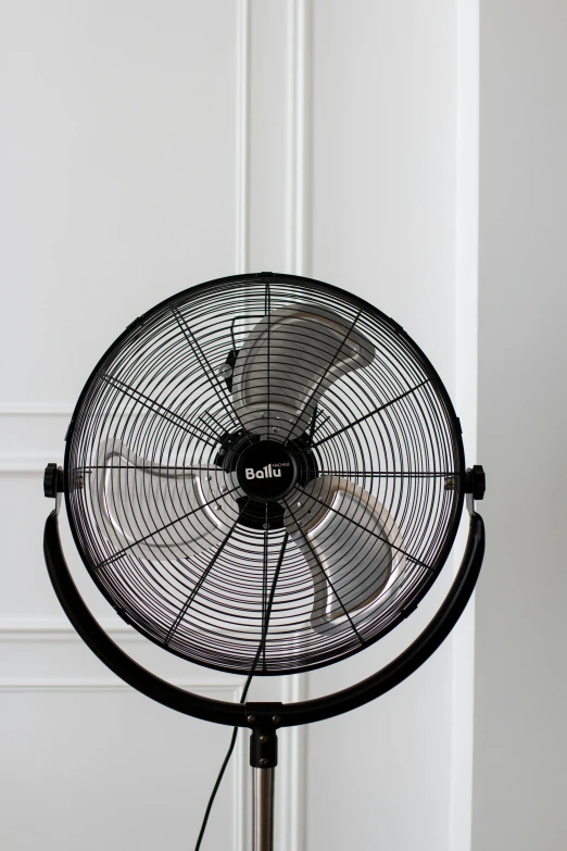 a large industrial fan sitting next to the wall