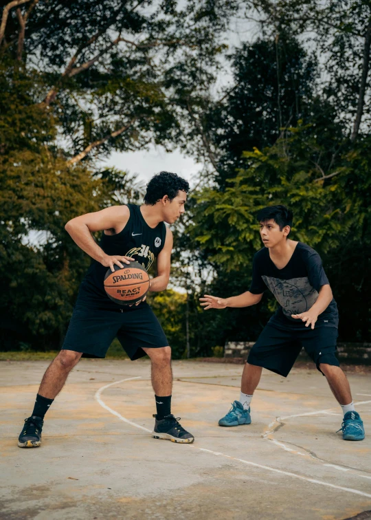 two guys with basketballs at a park about to play basketball