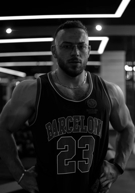 a man in a jersey standing and posing for the camera