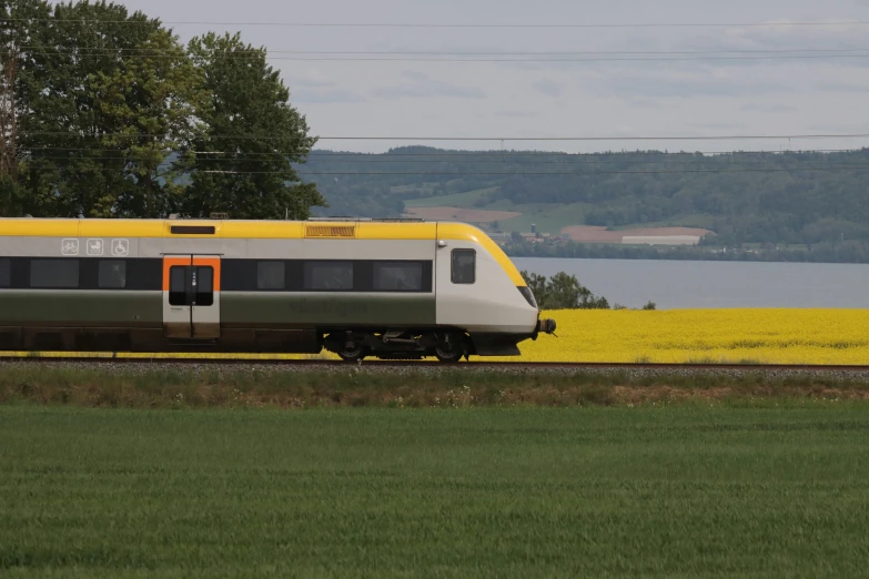 an old - fashioned train travels by the water