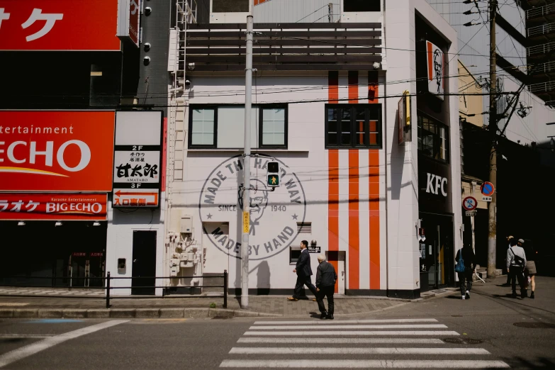 the pedestrian is walking down the busy street