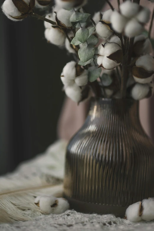 a white flower arrangement in a metallic vase