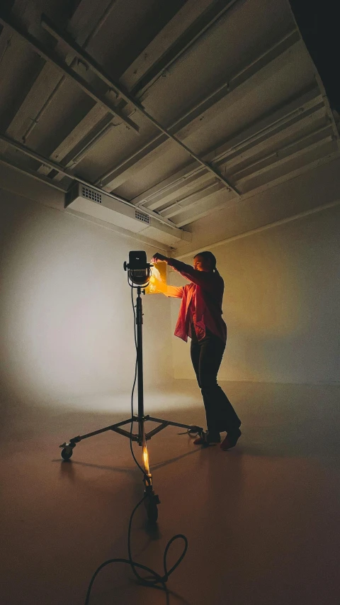 a woman lighting a light bulb for a po shoot