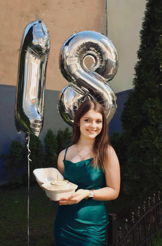 a girl in a green dress is holding a dish and the number 8