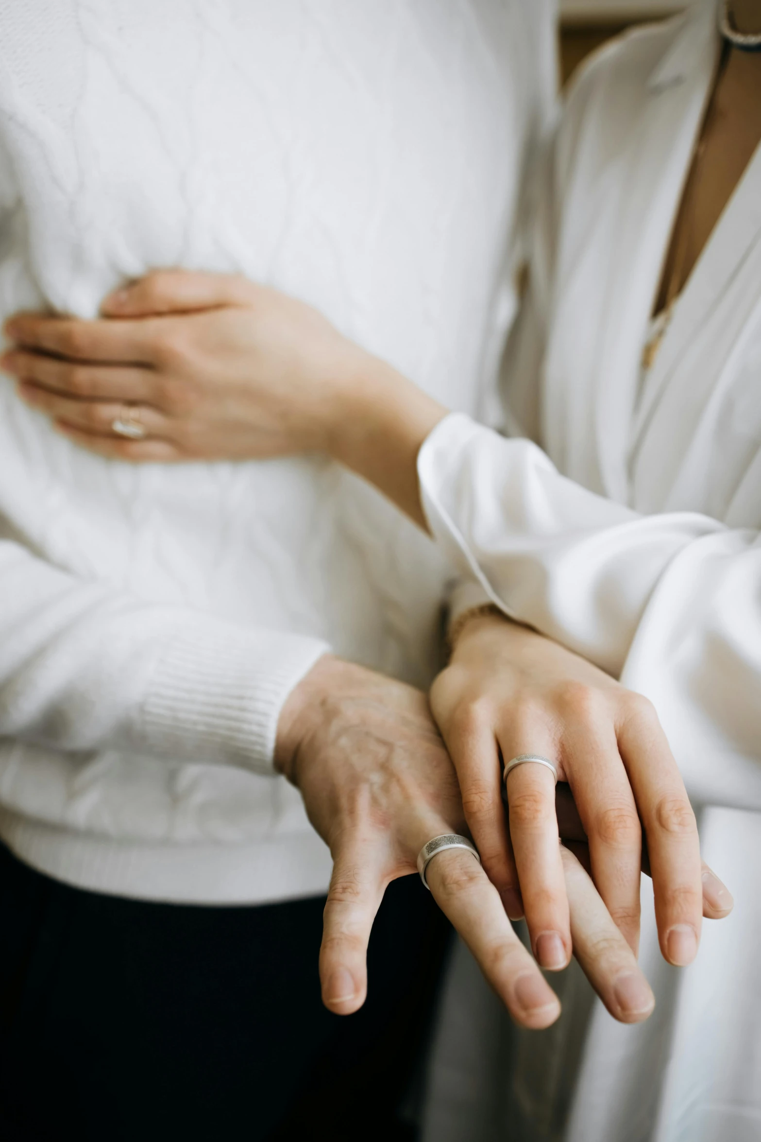 a person with a wedding ring on their fingers