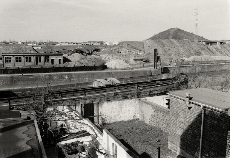 a black and white po shows a train moving through the dirt