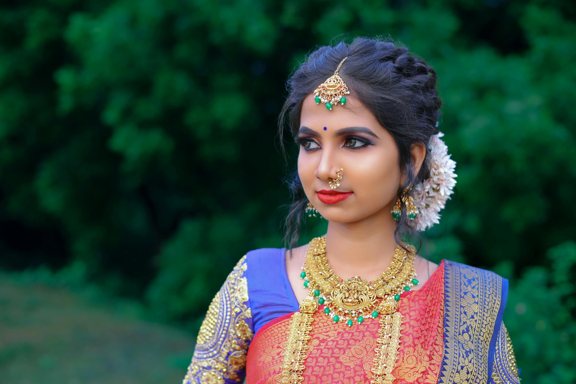 a beautiful indian woman in traditional clothes poses for the camera