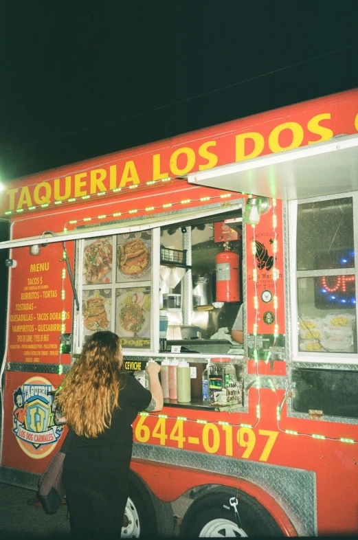 a girl ordering food at a mobile food truck