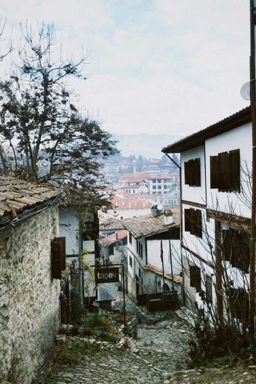 a street leading up a hill with buildings on the hillside