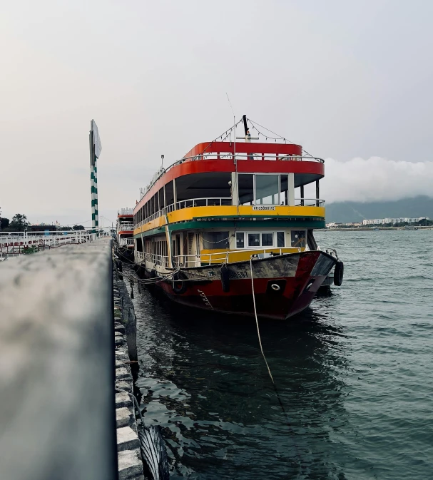 two boats on water, one is yellow and one is red