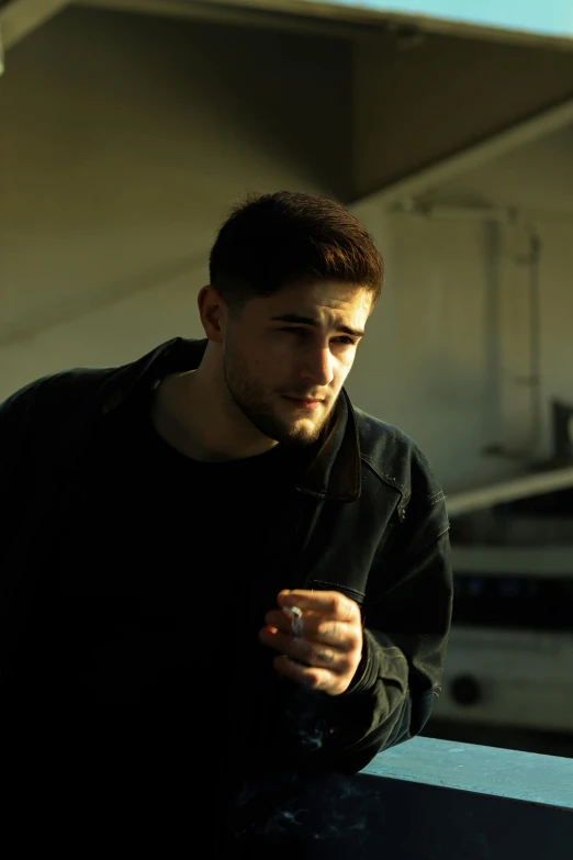 a man wearing a black shirt holds a cell phone