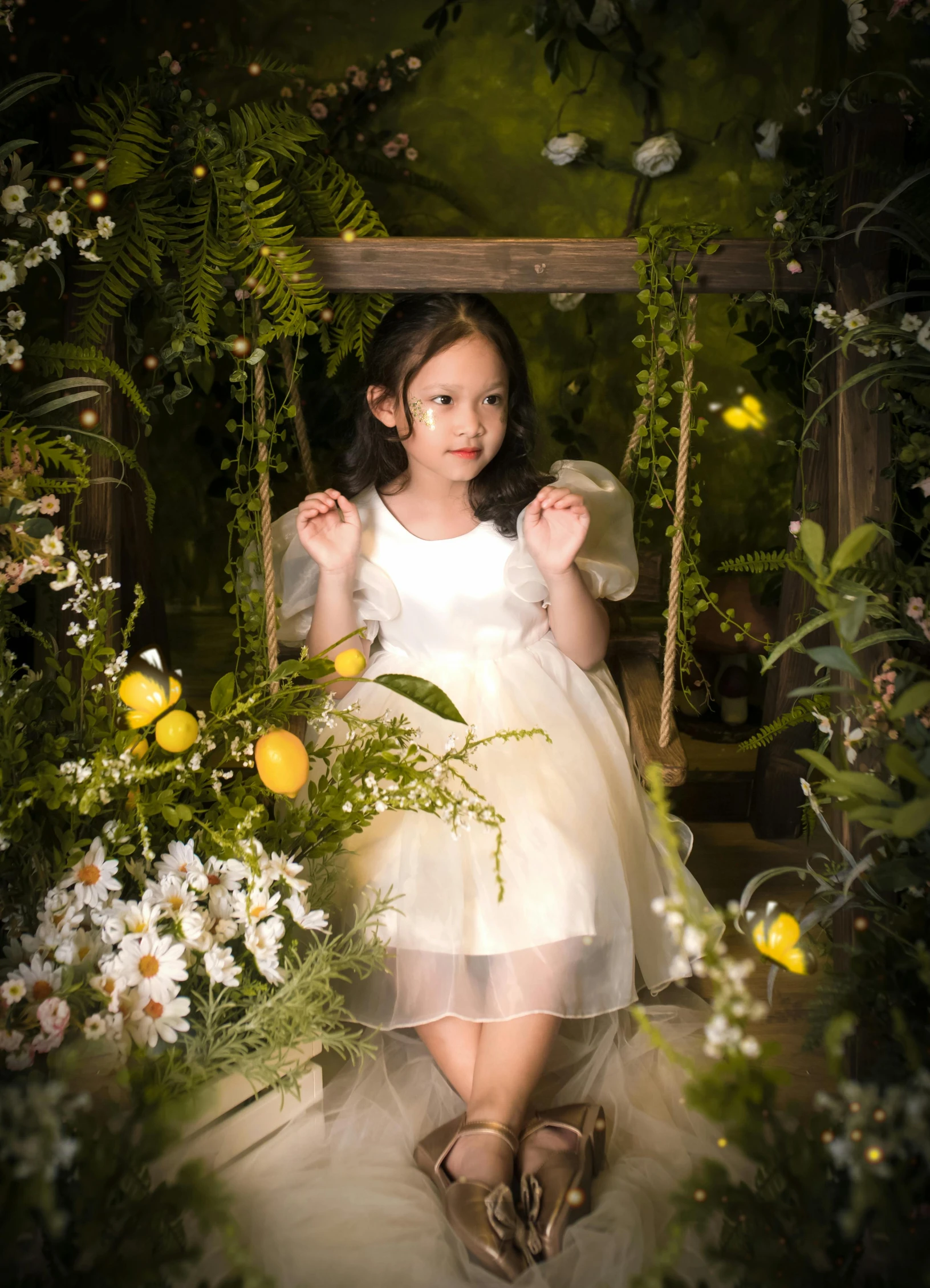 a  is wearing a white dress and is sitting on a swing