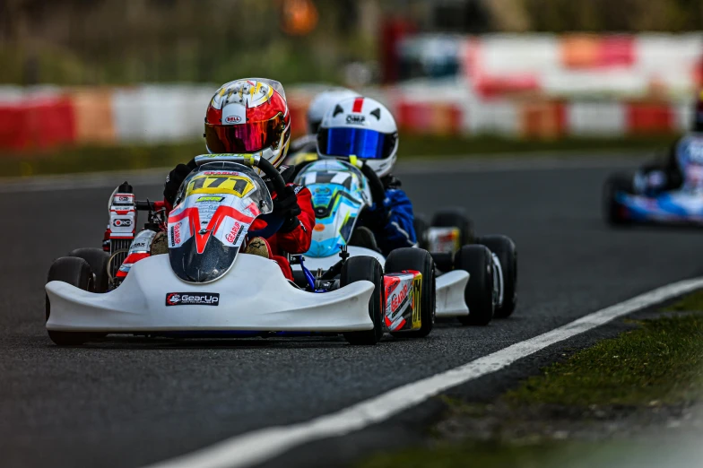 three people racing on their car in a race