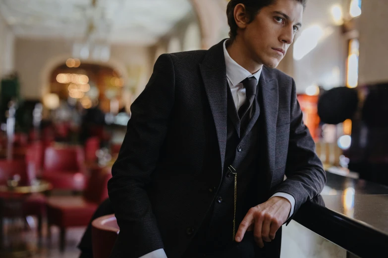 the man is leaning against a railing in the restaurant