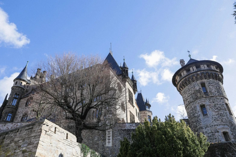 a tall castle with towers and a massive clock tower