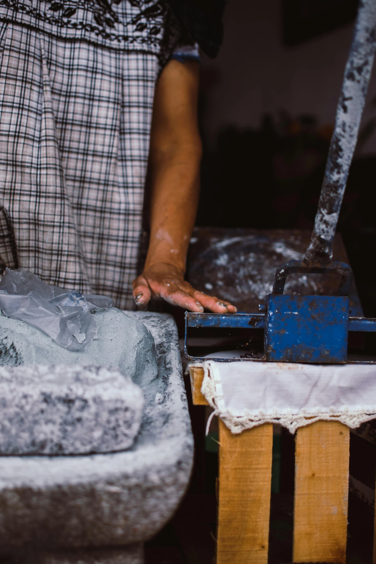 a person using a hammer to chisel up a piece of fabric