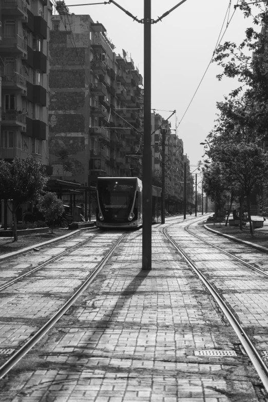 a black and white po of a tram on the tracks