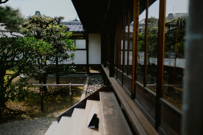 a japanese house with windows open and trees