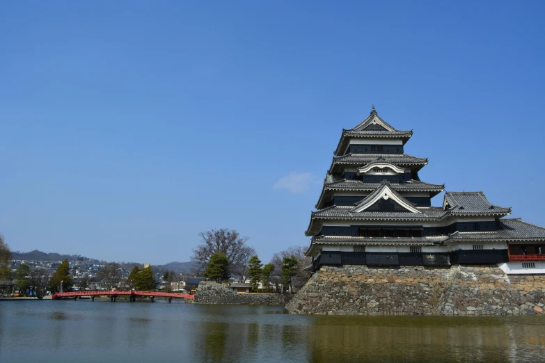 a castle next to a lake with boats parked on it