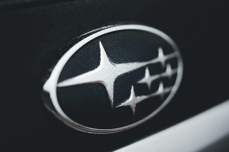 the emblem on a car is displayed with white lettering