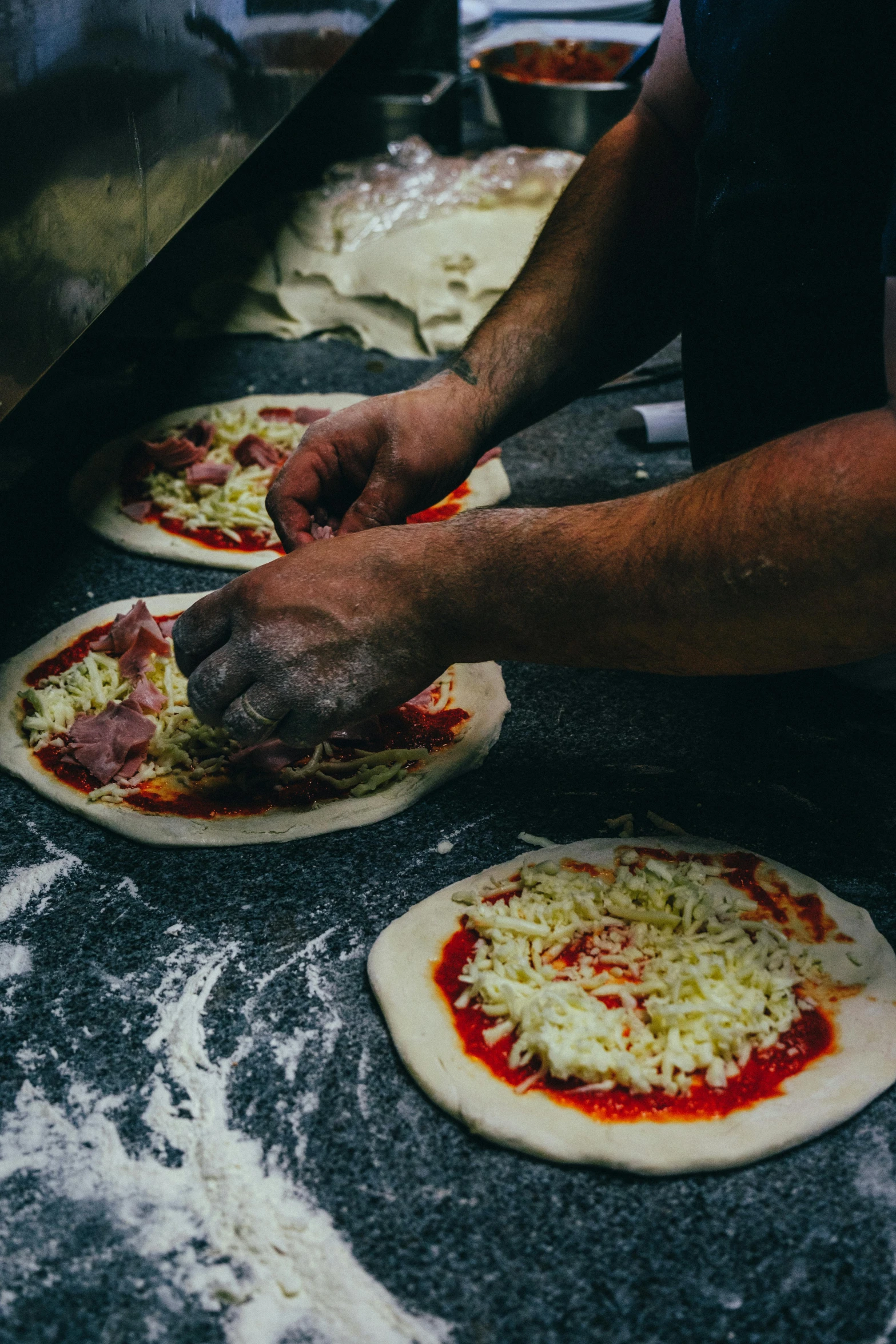 two pizzas on top of pizza stone counter top