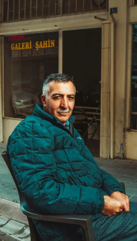 a man sits outside in an outdoor chair