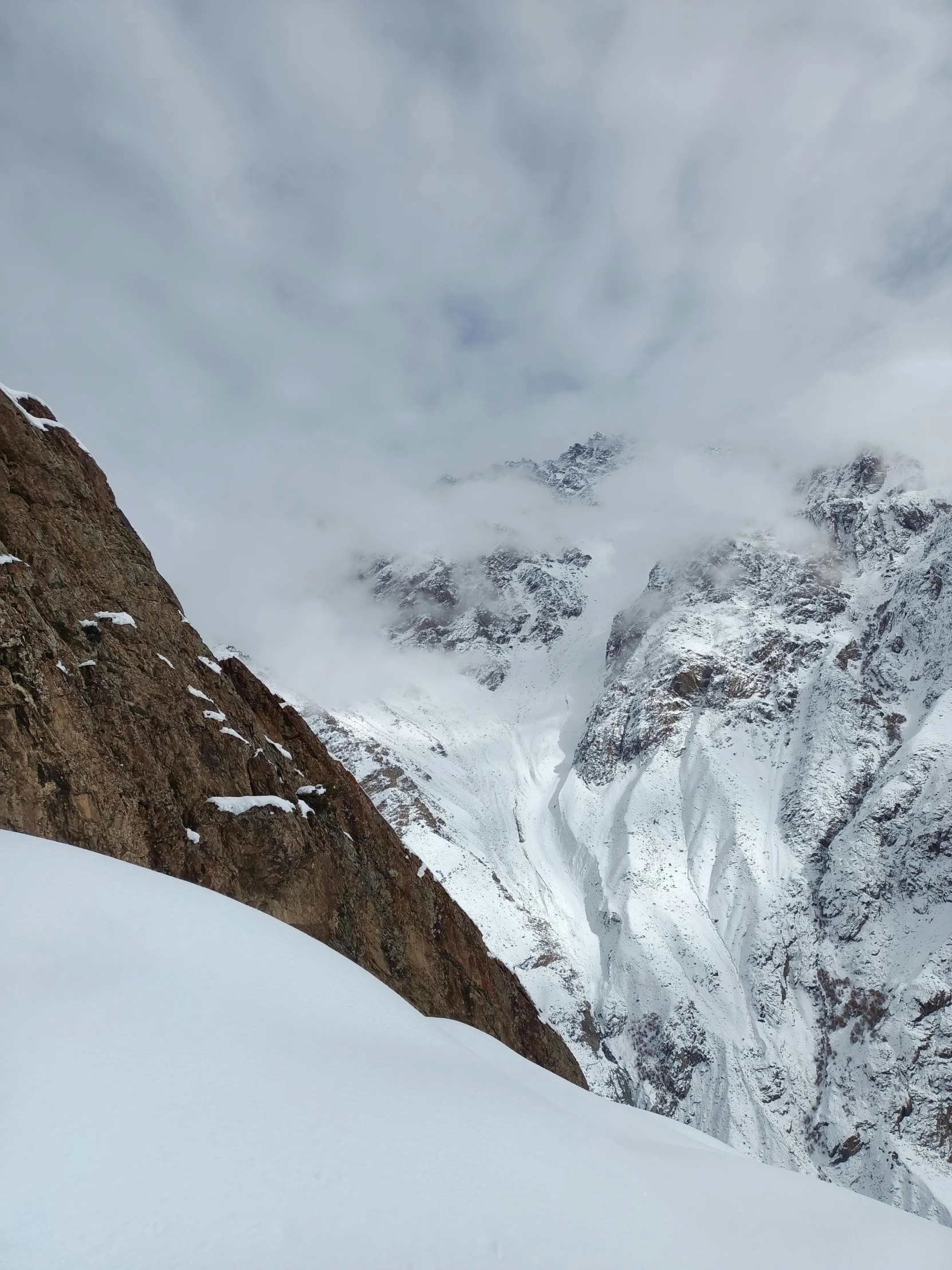 a man is snowboarding down a snowy mountain