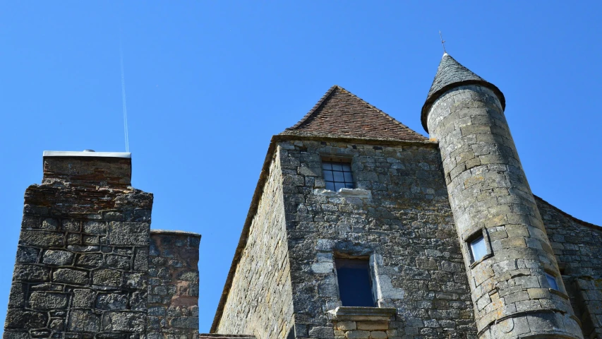 an old stone castle with a blue sky in the background