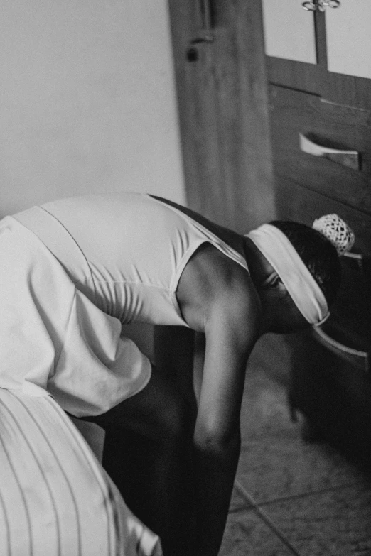 a woman sitting at a table wearing a hat