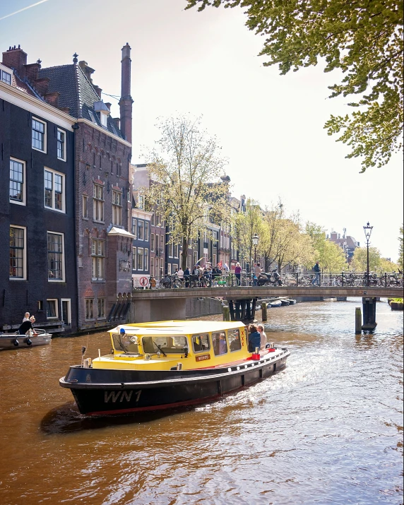 a boat in a canal near some buildings