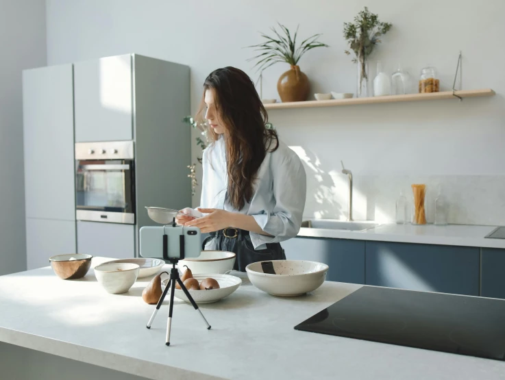 woman in kitchen mixing ingredients for cupcakes