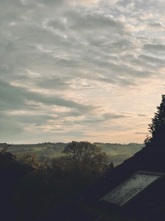 a lone bird is perched on the top of a house