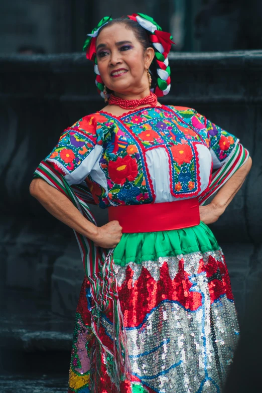 a woman is wearing a colorful dress with colorful decorations on it