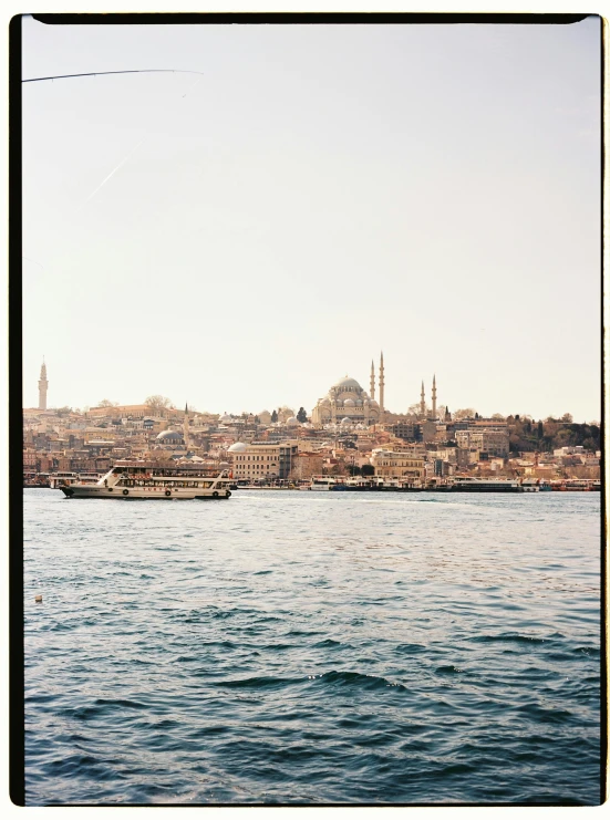 a large body of water with a city in the background