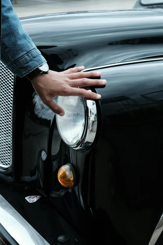 a close up of a person's hand on a car door handle