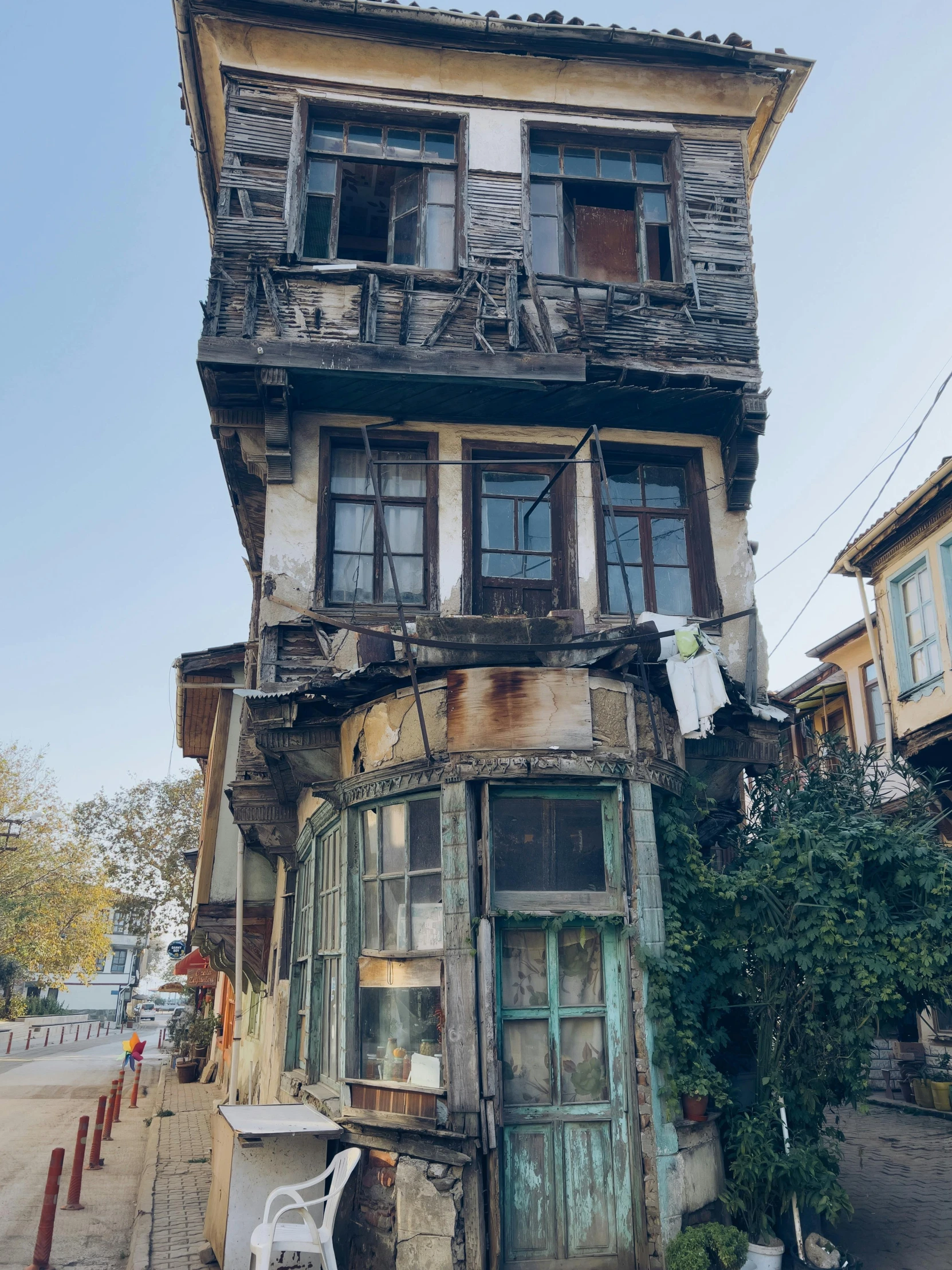 an old wooden house with no windows and a bench outside