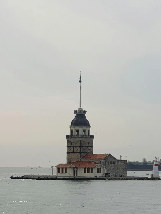 an ocean with two boats and one tower