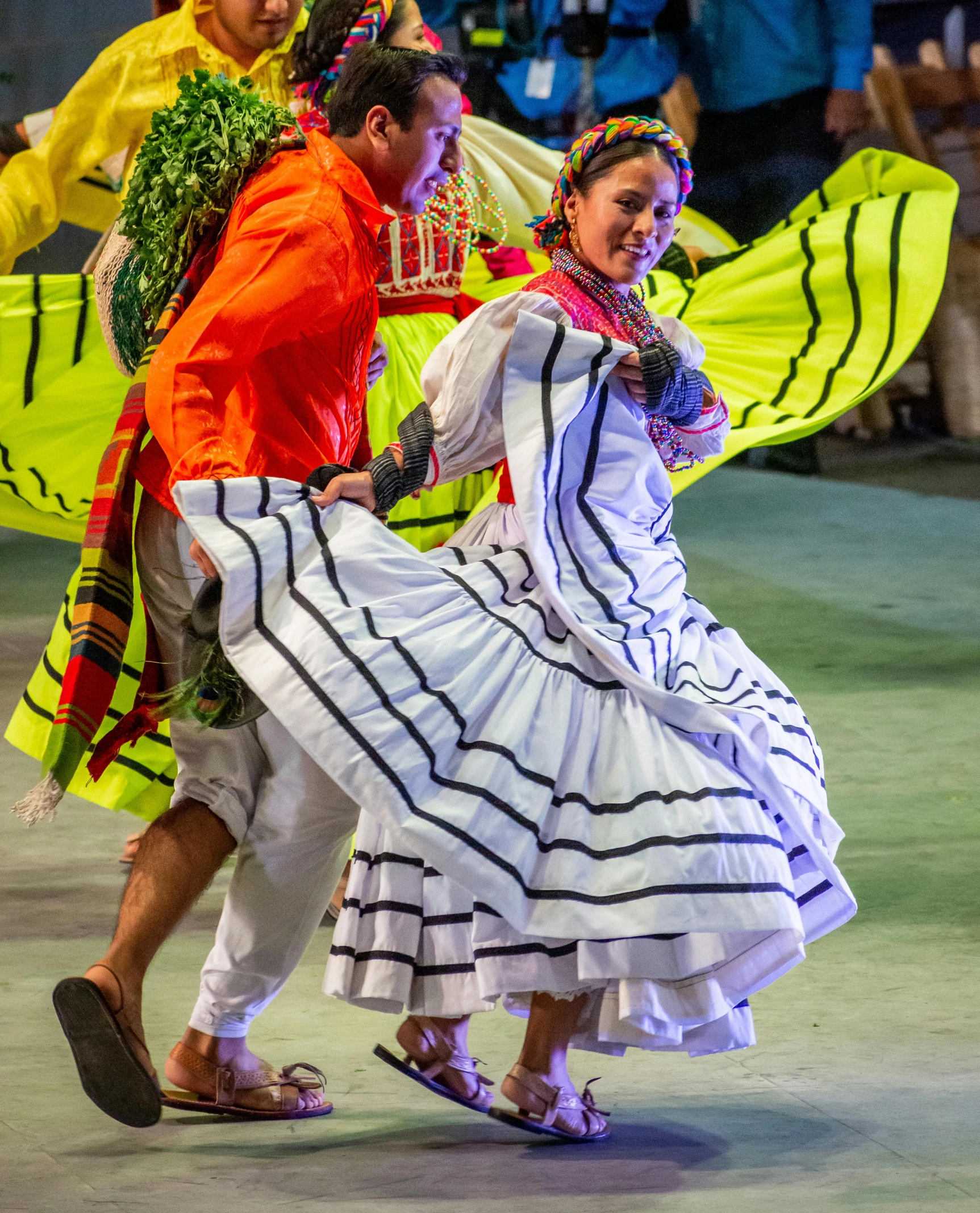 a group of people dancing with colorful umbrellas