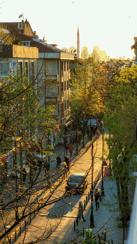 a busy city street and pedestrian traffic in the sunset