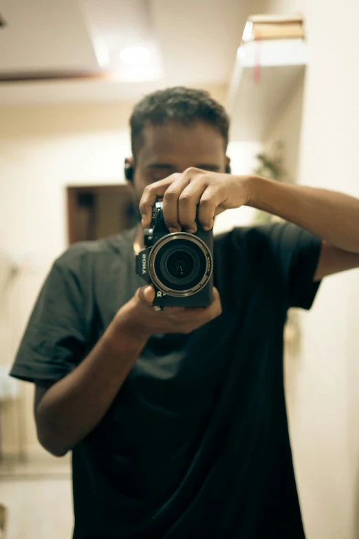 a man holding a camera to take a picture