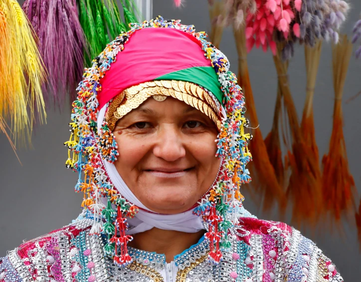a woman with colorful head pieces on her head