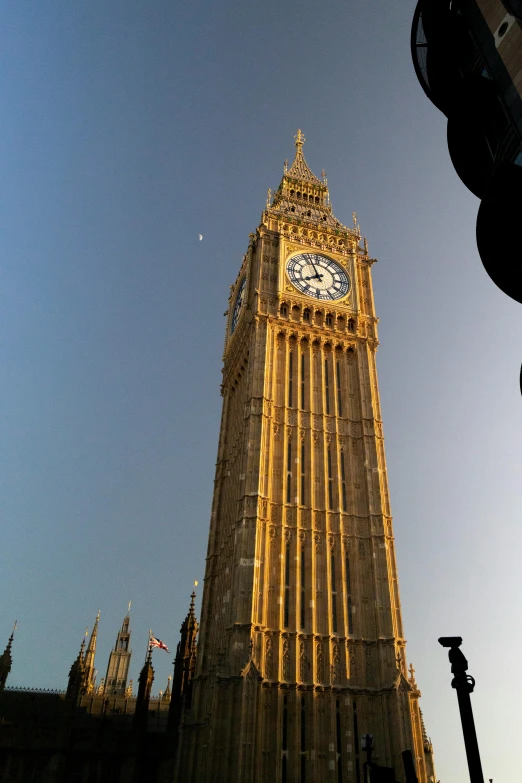 the large clock tower stands tall in the sunlight