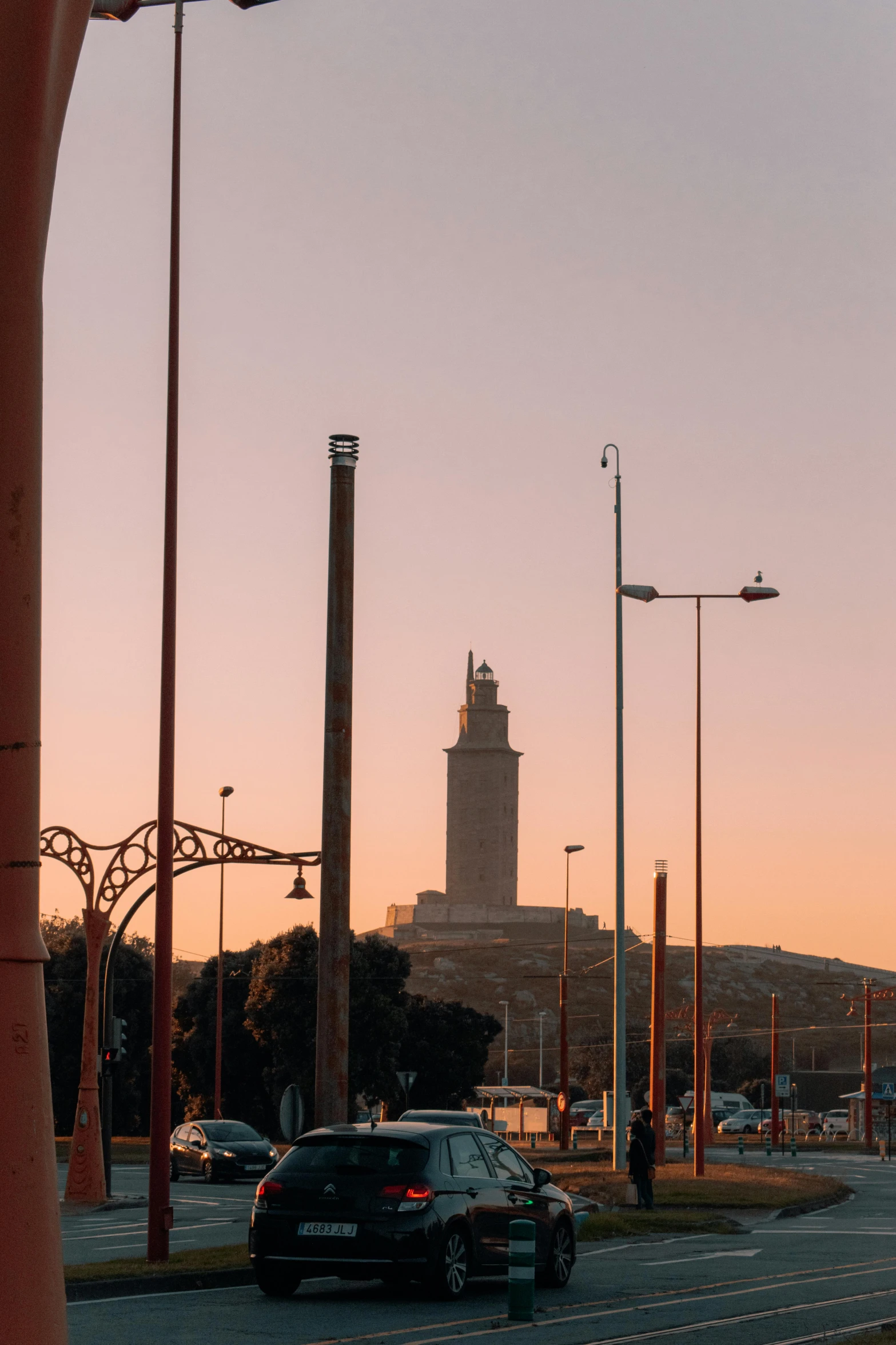 the city at sunset with a bus and several cars