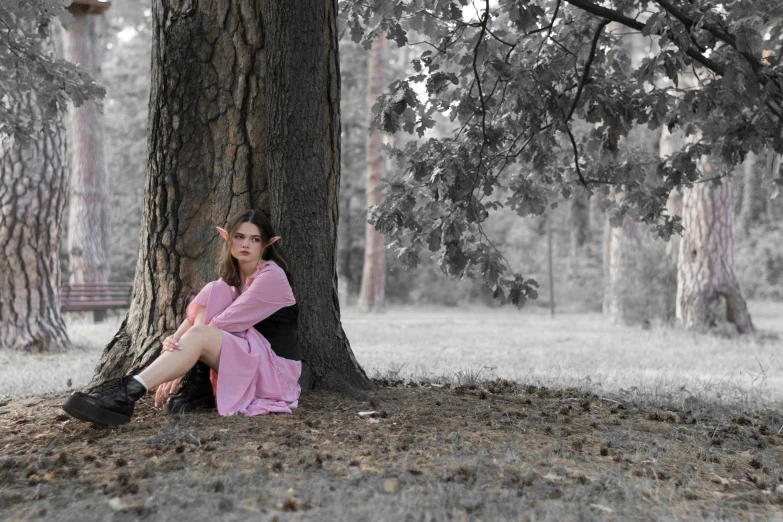 a woman with a tree and some trees