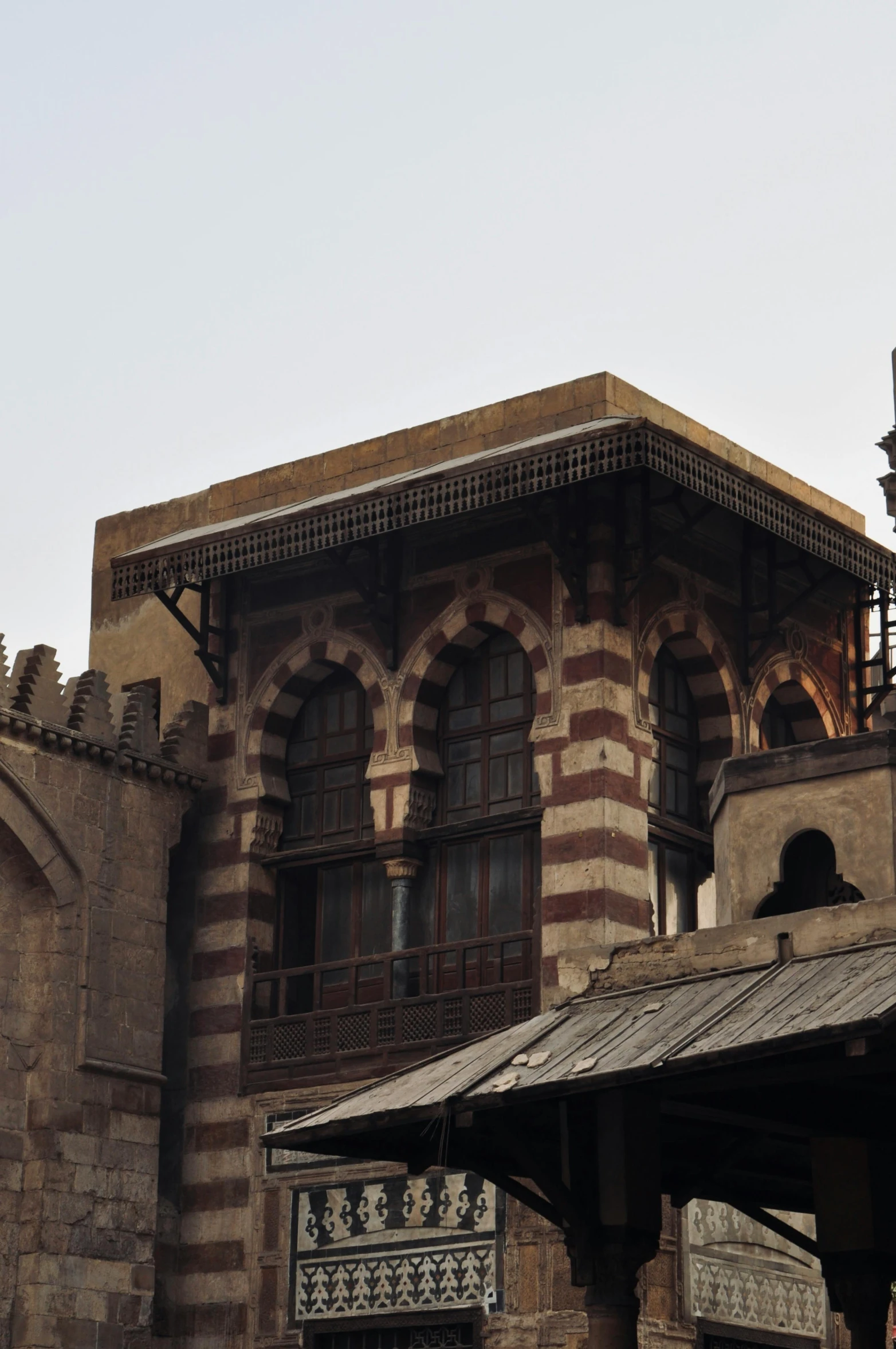 a brown and red brick building with some clock towers