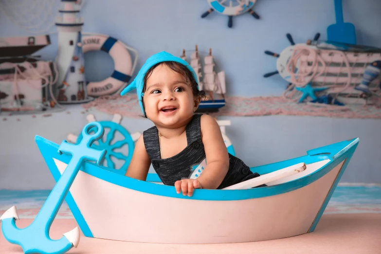 a small baby wearing a hat in a boat