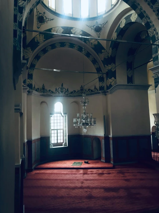 empty cathedral with red carpet and windows