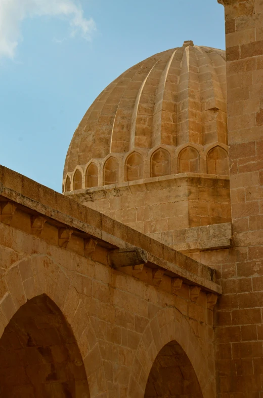 a dome shaped building with pillars in the corner